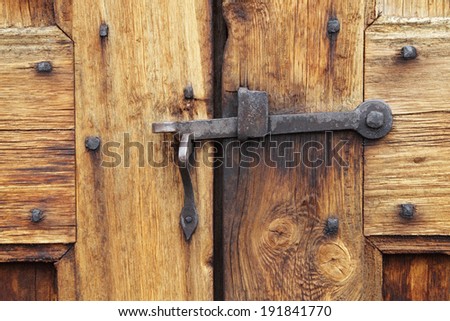 Old metal door closer on Norwegian church door