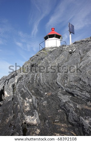 Small white lighthouse/light beacon with solar panel, using renewable energy