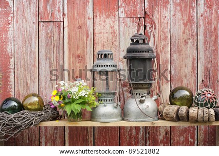 Antique fishing items and lamps at old boathouse wall in Norway