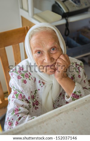 Portrait of the grandmother, on duty on a hostel...