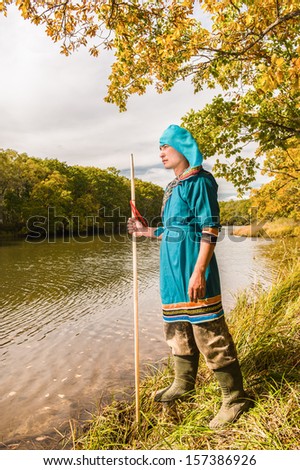 The young man from a sort of Udege looks out for fish in the river...