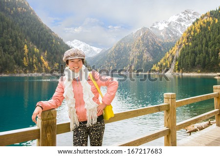 The cheerful tourist. People come to magnificent places of reserve Jiuzhaigou from all continents of a planet...
