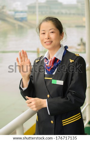 Hostess monitors the ship\'s departure from the city pier Wushan town ...