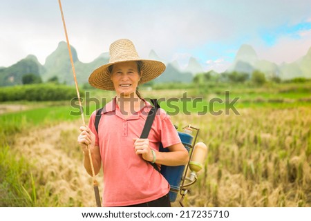 Portrait of a woman - farmer with a garden sprayer...