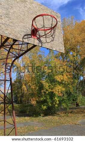 Basketball ring on athletic field in the autumn