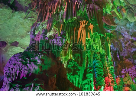 colorful limestone cave with perfect reflections in water