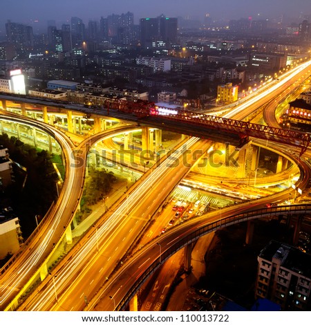 Overpass in the night with cars light in modern city