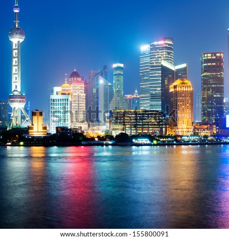Panoramic View Of Shanghai Skyline With Huangpu River At Dusk