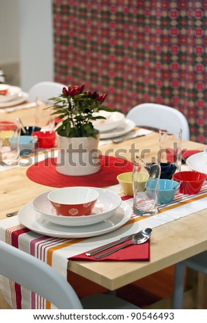 White, orange, red, yellow, turquoise and blue decorated dining table in restaurant