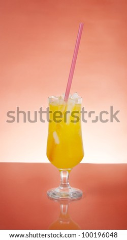 Glass of sprite with a pipe on orange backlight