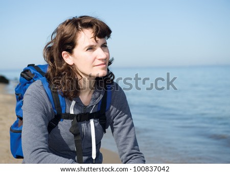 Close-up portrait of hiking woman relaxing at sea