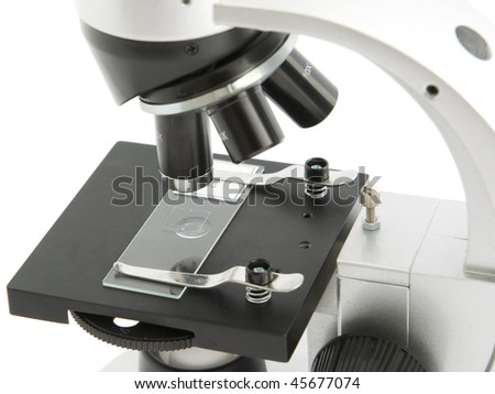 Part of grey microscope on white background