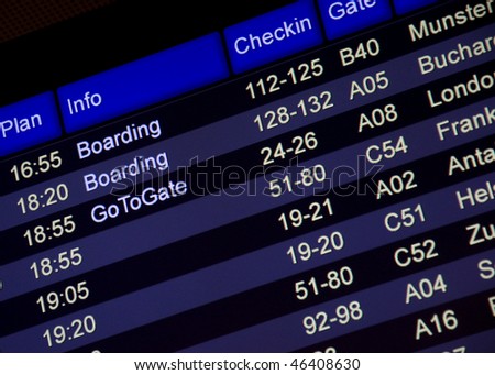 Departure board with info: Boarding, Go To Gate on a black-blue board