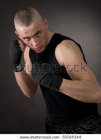 Kickboxing man with scar face exercising.