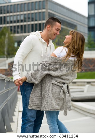 Young couple in love dancing in the city. Love story series