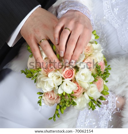 stock photo Hands with wedding rings and fower bouquet
