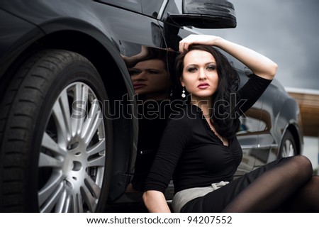 Sexy young woman and black sport car