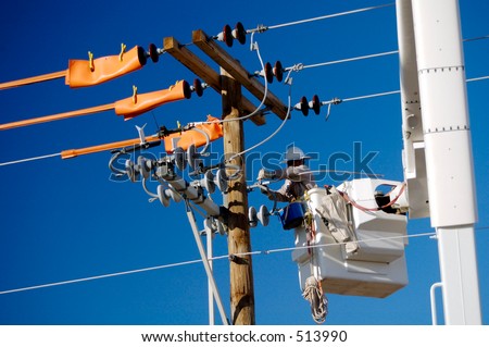 Electric utility lineman working on power lines.