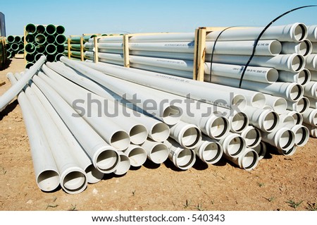 A bundle of sewer pipe at a residential home construction site.