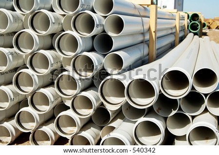A bundle of sewer pipe at a residential home construction site.