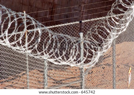 Chain link fence with razor wire.