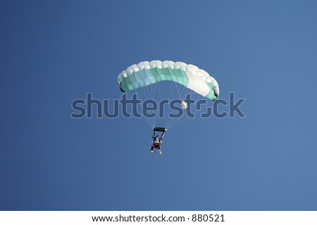 Skydivers prepare to land during a tandem jump.