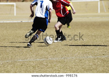 A fight for the soccer ball in a youth soccer game.