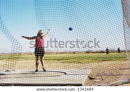 Women\'s discus competition at a college track meet.