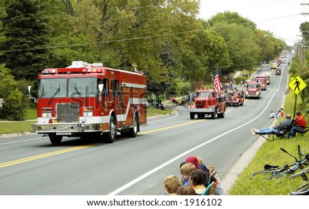 Fire and rescue vehicles being driven in a fire muster parade.