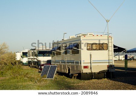 Camping in the desert with solar panels for converting energy from the sun to electricity.