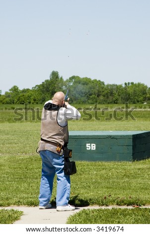 breaking a clay pigeons at a trap shoot range