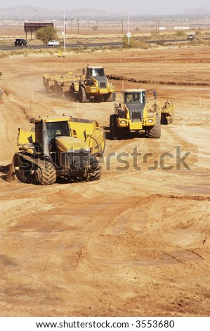 earthmoving equipment at work preparing a construction site for development.