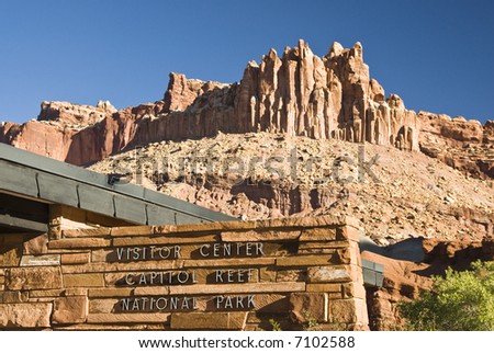the Visitors center at Capital Reef National Park with The Castle, a red sandstone formation in the background.