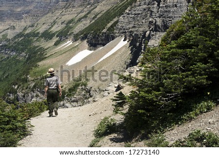 a park ranger walking on Highline Trail in Glacier National Park