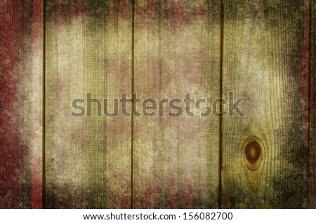 Photograph of raw wood planking, processed to give a weathered,  grungy and rustic appearance with a blend of dark red, green and white hues.  Darker edges give a sense of a border or frame.