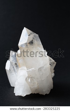 A quartz crystal cluster against a black background.