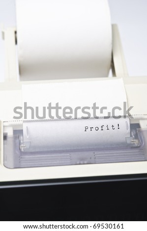Close up of a calculator ink roll, printing the word Profit.