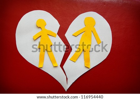 paper cutout couple on a torn heart -  divorce concept