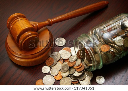 legal gavel and coins in a coin jar