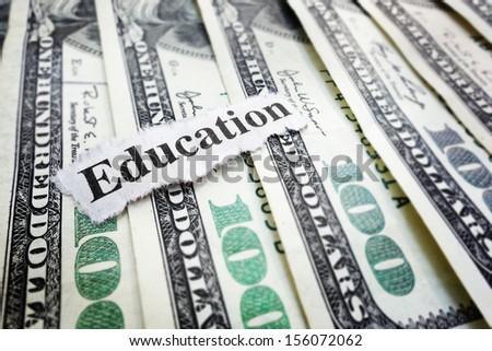 Closeup Of Hundred Dollar Bills And &Quot;Education&Quot; News Headline