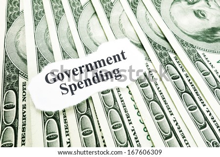 Government Spending text on a paper scrap over money