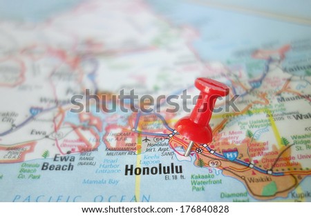 Closeup of a red pushpin in a map of Hawaii