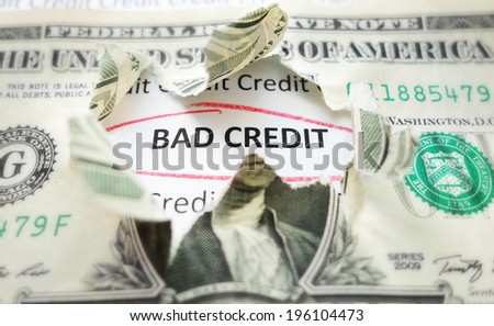 Bad Credit text under a torn dollar bill