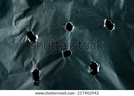 Bullet holes in metal textured background