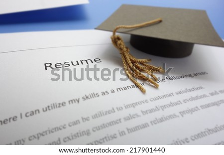 Job applicant resume and graduation cap