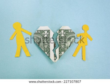 Paper couple and broken dollar heart - divorce or money trouble concept