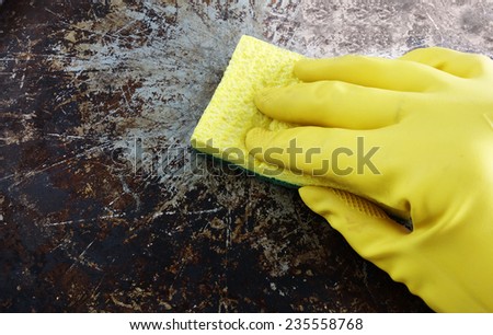 Greasy pot or pan being scrubbed by hand