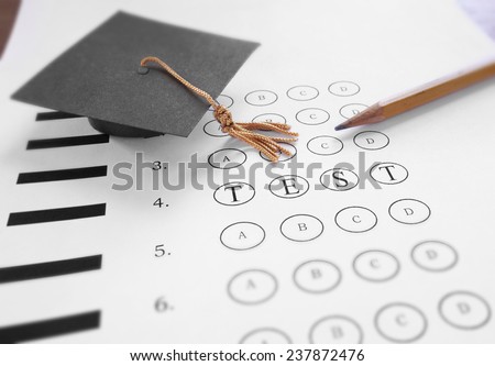 Mini mortar board graduation cap and Test text on multiple choice exam