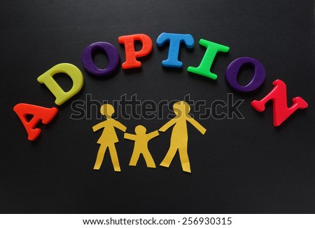 Paper cutout family of three with Adoption letters