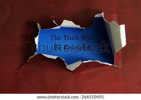 hole torn in a piece of paper with The Truth Will Be Revealed